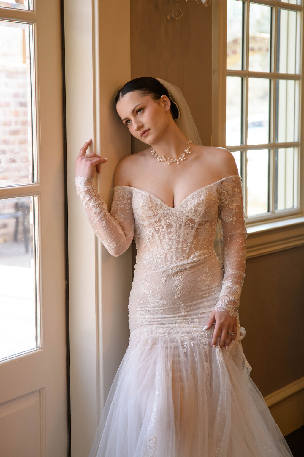 Bride Wearing Floating Pearl Necklace and Vintage Lace Wedding Dress