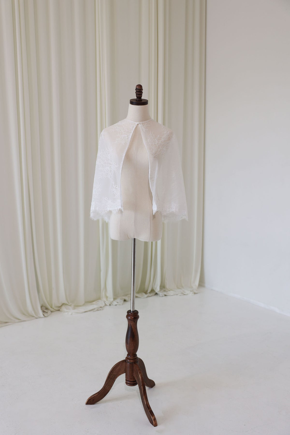 Bride Wearing Lace Bridal Cape over Wedding Dress