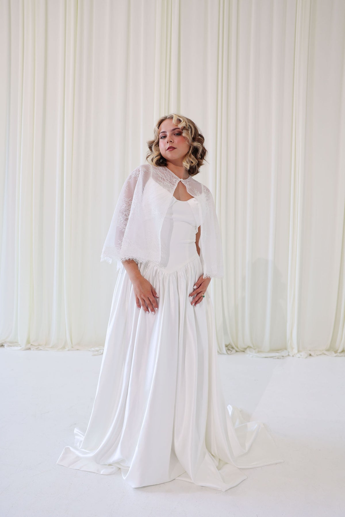 Bride Wearing Lace Bridal Cape over Wedding Dress