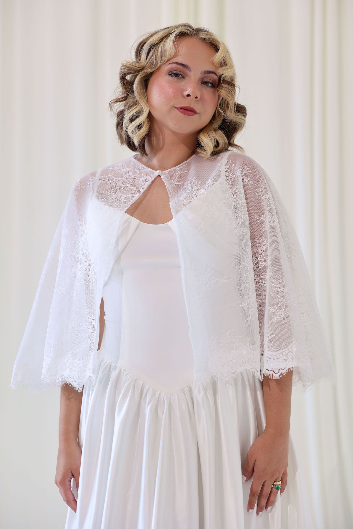 Bride Wearing Lace Bridal Cape over Wedding Dress