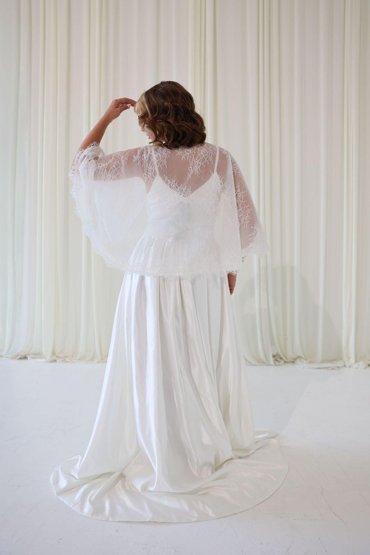 Bride Wearing Lace Bridal Cape over Wedding Dress
