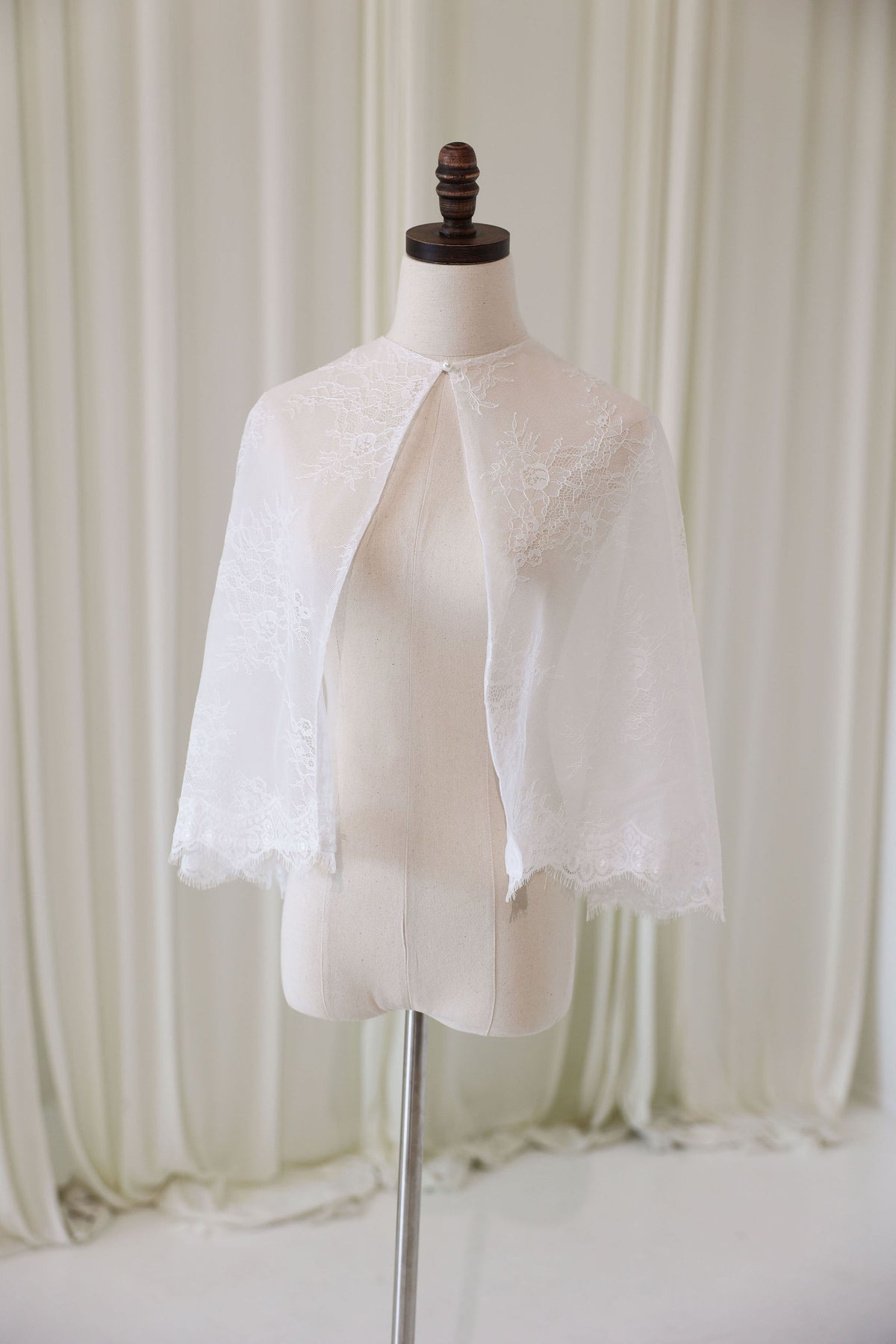 Bride Wearing Lace Bridal Cape over Wedding Dress