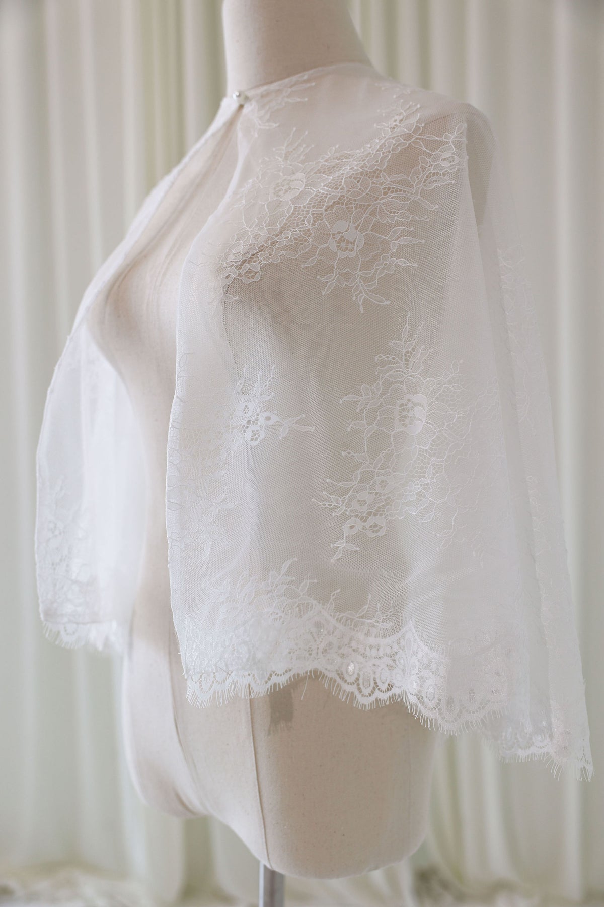 Bride Wearing Lace Bridal Cape over Wedding Dress